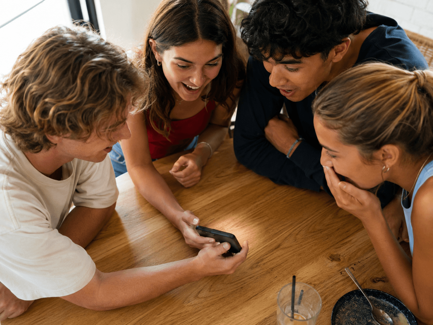 A group of friends smiling together after a successful group buy
